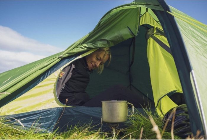 Woman sat in a green tent