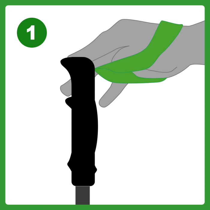 Hand through wrist strap with finger tips on the top of the pole
