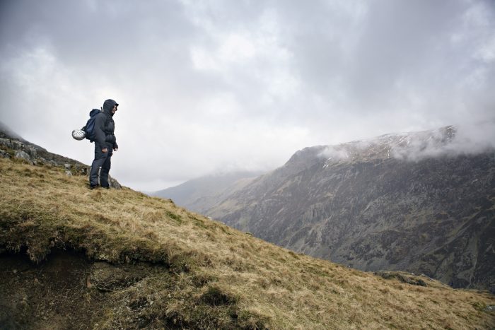 Hiker stood at the top of a mountain