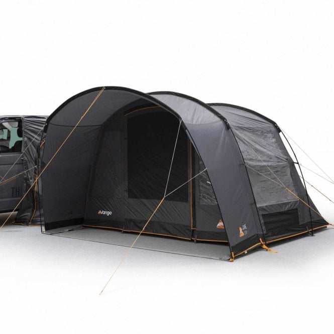 A poled awning set up beside a car